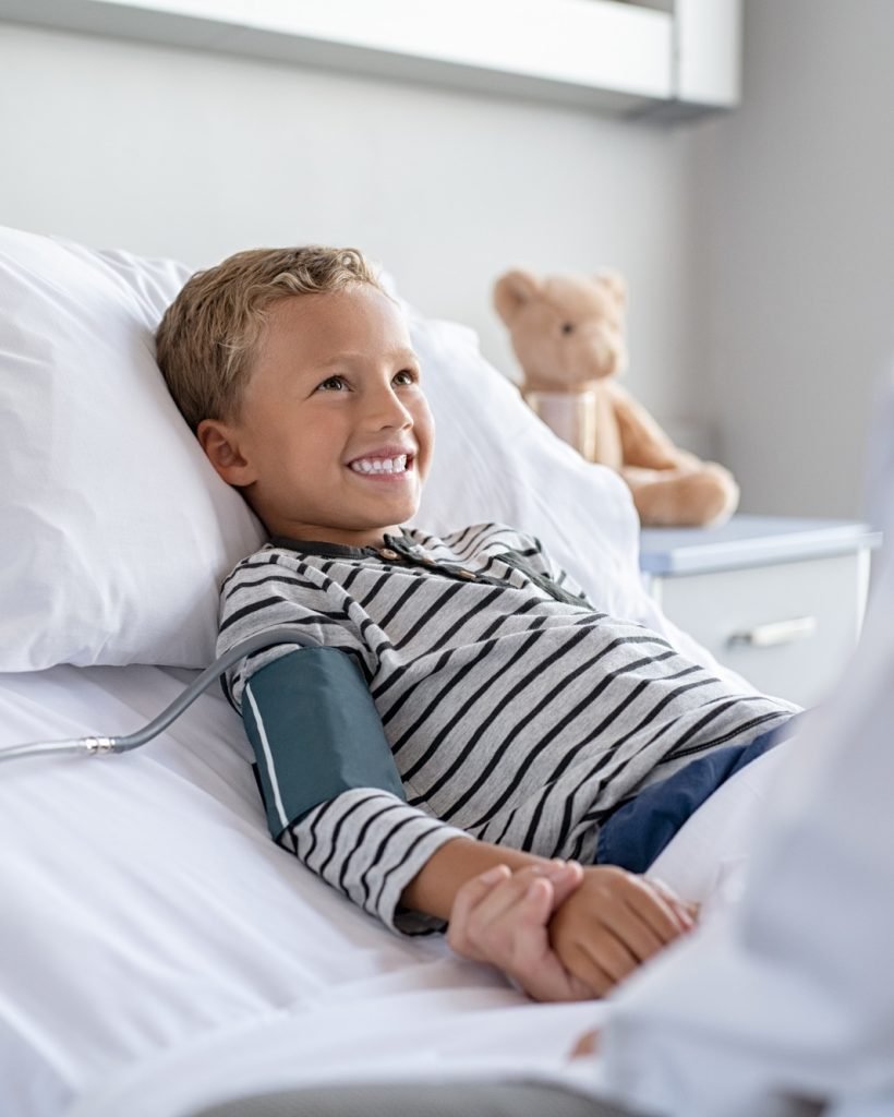 Cute boy lying on hospital bed