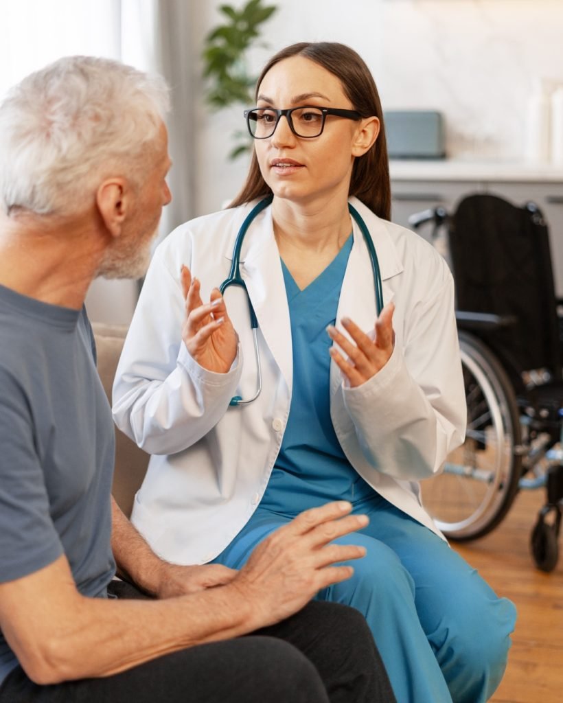 Female doctor explaining diagnosis to senior patient at home