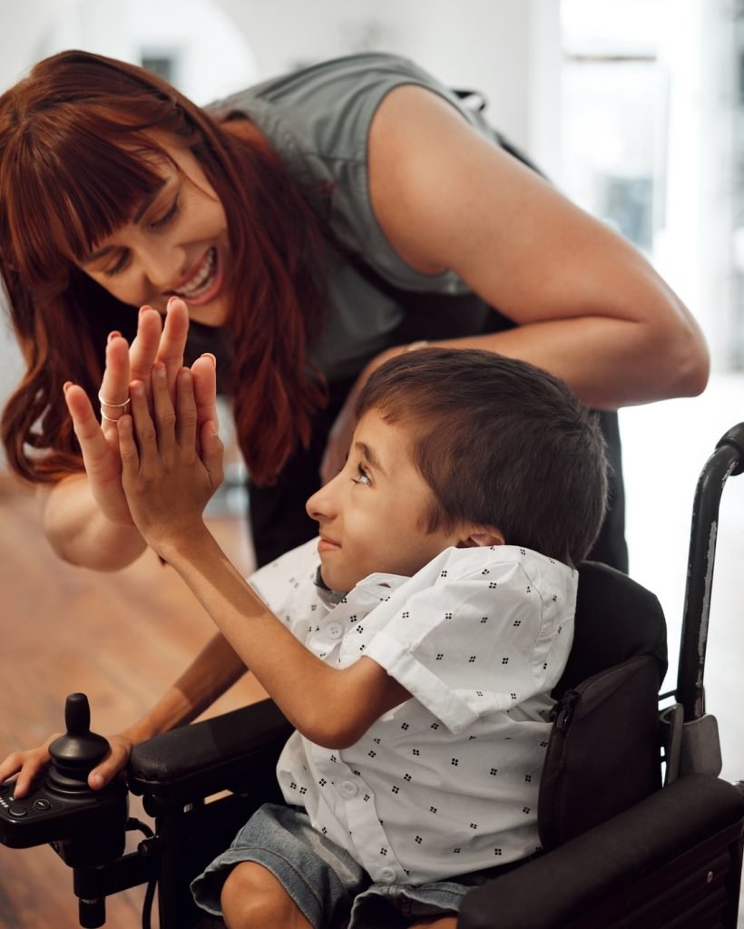 Hairdresser, high five and child in hair salon happy with hair cut or hairstyle. Disabled kid in wh