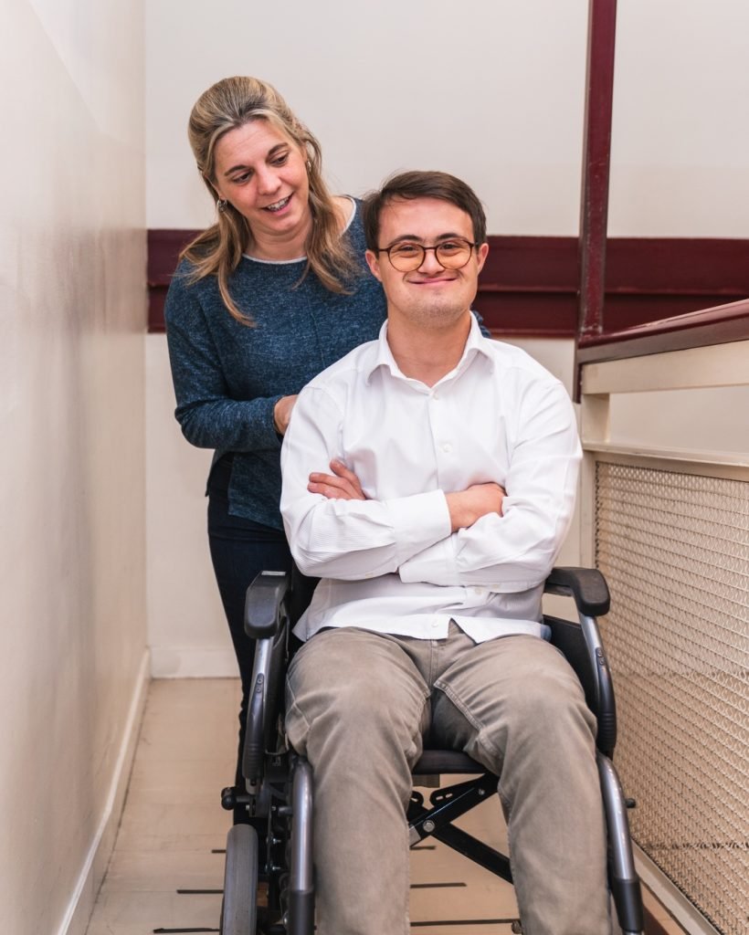 Warm Companionship: Supportive Woman Pushing Man's Wheelchair